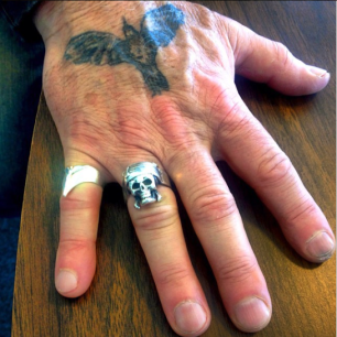 Bill Carter’s right hand, primarily the pirate skull ring given to him by close friend and fellow artist, Johnny Depp. Photography by the writer, Nicolette Mallow.